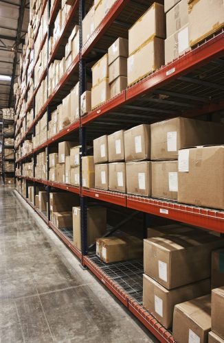 Cardboard boxes on shelves in warehouse